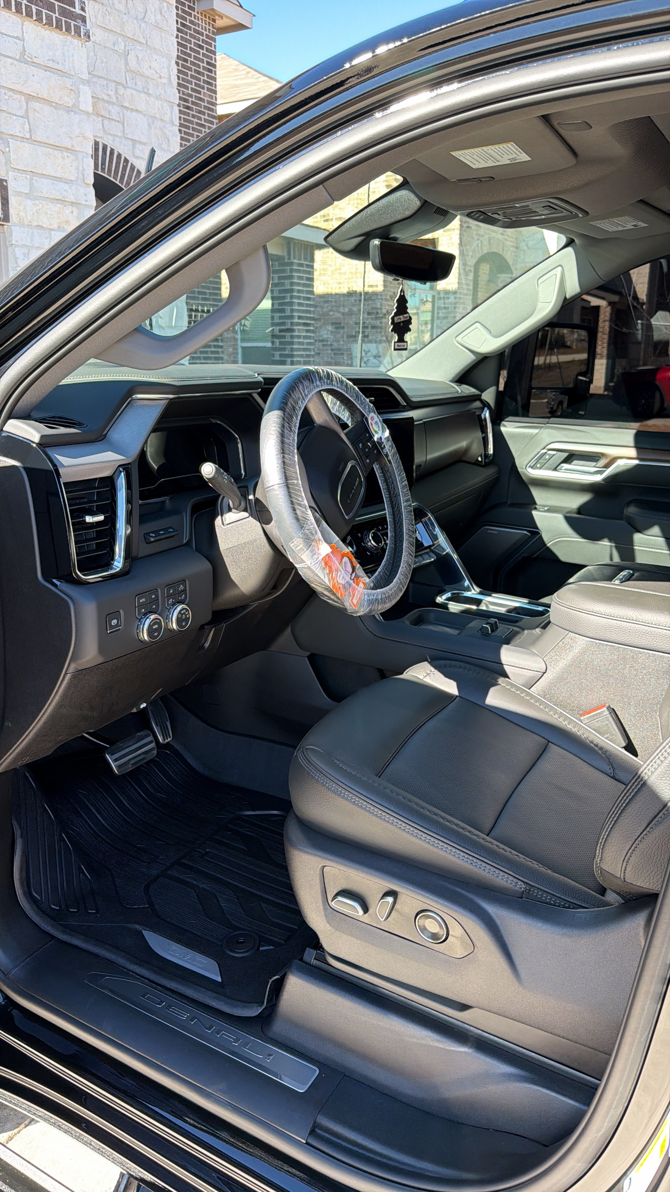 GMC Sierra Denali interior detail showing clean leather seats and dashboard in Shavano Park TX